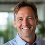 Headshot of Alex Olsson, a man in his 40s with a warm, approachable smile